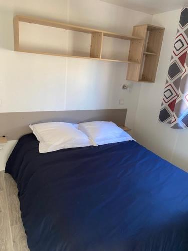 מיטה או מיטות בחדר ב-Camping de la Mer