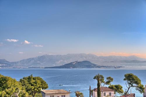 a view of a large body of water with mountains at Aquamarin - Premium Seaview Apartment in Slatine
