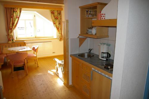a kitchen with a sink and a table and a window at Appartement Wildspitz' in Vent