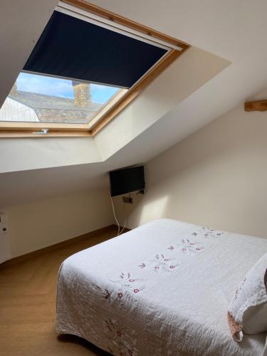 a bedroom with a bed and a large window at Ave del Mar in Camariñas
