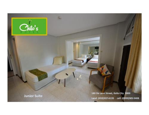 a hotel room with a bed and a table at Chito's Hotel in Iloilo City