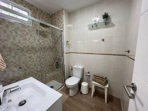 a bathroom with a toilet and a sink and a shower at Piteras Las Americas in Arona