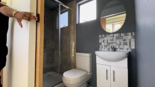 a bathroom with a toilet and a sink and a mirror at KgotsoCarter TF1 in Johannesburg