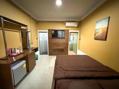 a bedroom with a bed and a television in it at Baan Chiang Maan in Chiang Mai