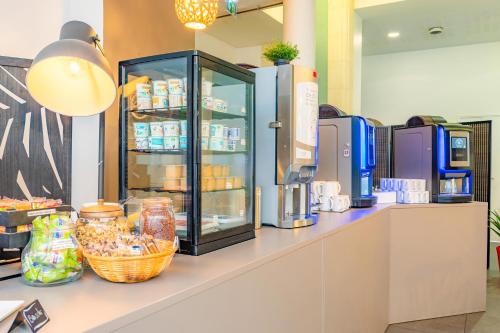 a counter in a store with a drink cooler at Appart’City Confort Nantes Centre in Nantes