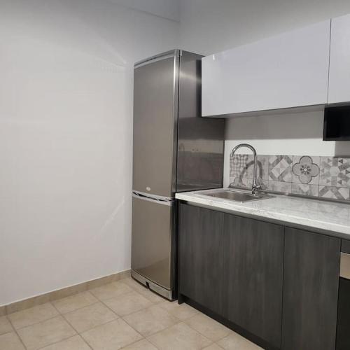 a kitchen with a sink and a refrigerator at GREAT APARTMENT IN VERIA in Veria