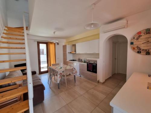 a kitchen and a living room with a table at Borgo Vigata in Punta Secca