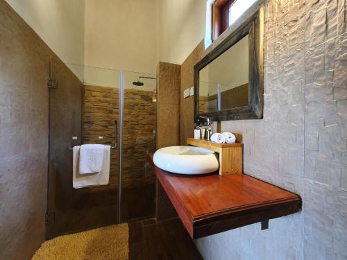 a bathroom with a sink and a mirror and a shower at Zaburi Beach by Serendib in Mponda