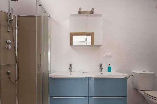 a bathroom with a sink and a shower at Les Oliviers - Studios & Apartments in Vourvourou