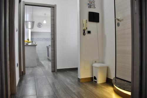a room with a hallway with a toilet and a kitchen at Sapore di mare Home in Santa Domenica