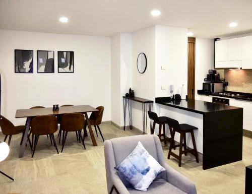 a kitchen and living room with a table and chairs at Flats Friends Condesa-Pelotari in Mexico City