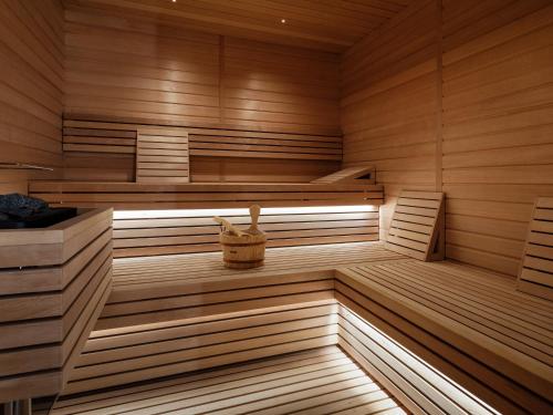 a wooden sauna with a basket in the middle at The Amauris Vienna - Relais & Châteaux in Vienna