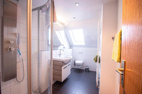 a bathroom with a shower and a sink and a toilet at Landhaus Müden in Faßberg