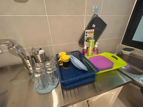 a kitchen counter with a tray and utensils on it at P' Residence Condo, Batu Kawa, Kuching in Kuching