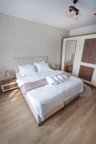 a bedroom with a large white bed with a large mirror at King Suite BH37 in Istanbul