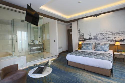 a hotel room with a large bed and a television at AHC Ayasofya Hotel - Special Class in Istanbul