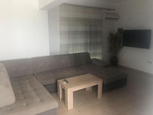 a living room with a couch and a coffee table at Toula's Apartments in Faliraki