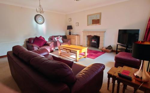 a living room with a couch and a coffee table at Rosebank Lodge in High Bentham