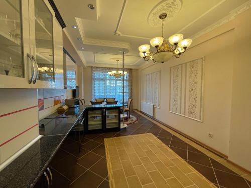 a hallway of a home with a chandelier at Park Azure Residence in Baku