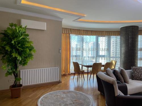 a living room with a couch and a table at Park Azure Residence in Baku