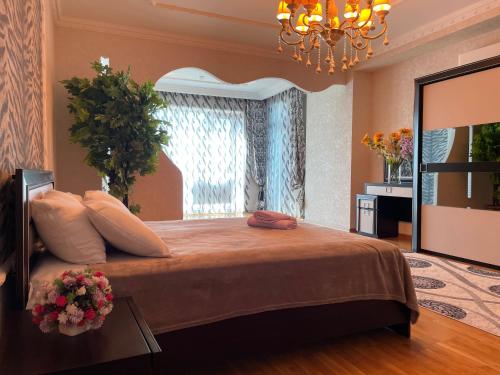 a bedroom with a large bed with a window at Park Azure Residence in Baku