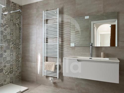a bathroom with a sink and a mirror at Villa Alysa - spiaggia a 400m in Porto Cesareo
