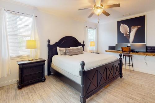a bedroom with a bed and a ceiling fan at Cassie's Beach Cottage in Destin
