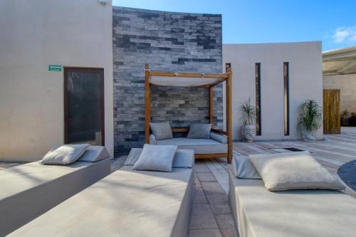 two beds on a patio with a bed frame at Adora Tulum 406 at Av Kukulkan in Tulum