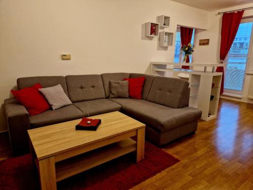 a living room with a couch and a coffee table at Slnečný byt v blízkosti historického centra Free Parking in Trenčín