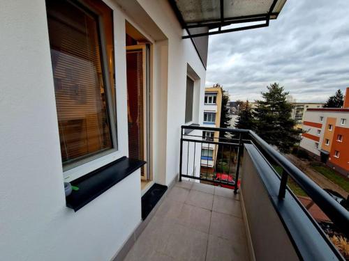 a balcony of a building with a view of a city at Slnečný byt v blízkosti historického centra Free Parking in Trenčín