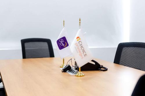a table with two flags on top of it at Sleep Inn Leon Antares in León