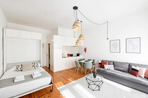 a living room with two beds and a couch at LovelyStay - Cativo Studio Downtown by Metro Station in Porto