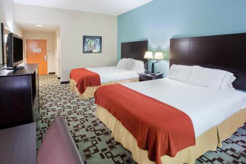 a hotel room with two beds and a flat screen tv at Holiday Inn Express Apex - Raleigh, an IHG Hotel in Apex