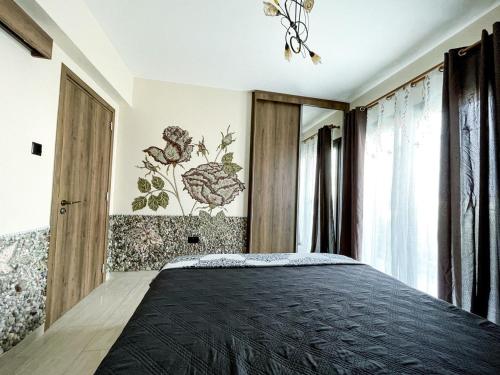 a bedroom with a large bed with a black blanket at Mosaic villa by the sea in Protaras