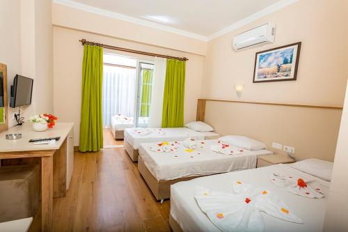 A bed or beds in a room at Rich Melissa Hotel