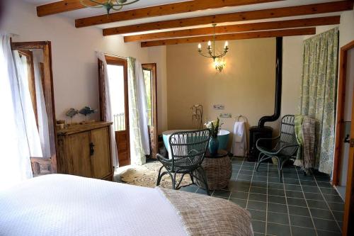 a bedroom with a bed and a table and chairs at La Campana de Finestrat in Finestrat