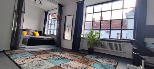a bedroom with a bed and two windows at Loft46 - Self Checkin - Long and Shortstay in Berlin
