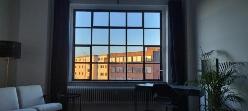 a window with a view of a building outside at Loft46 - Self Checkin - Long and Shortstay in Berlin