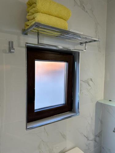 a bathroom with a mirror and towels on a wall at Tenerife Sur Habitación de Lujo in Adeje
