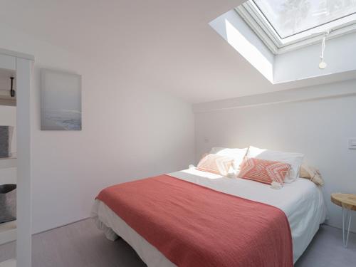 a white bedroom with a bed with a red blanket at Aquarium Bungalow private jacuzzi, 3 bedrooms, AC and Bikes in Maspalomas