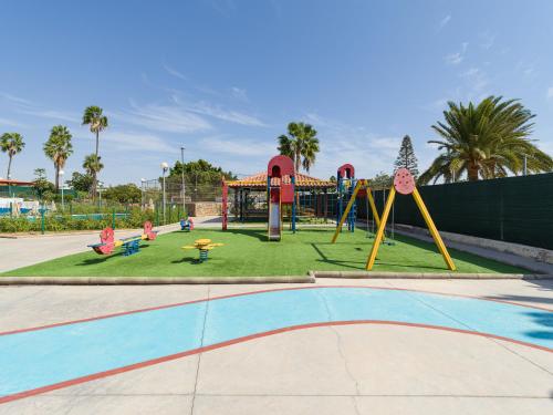 a playground in a park with a roller coaster at Aquarium Bungalow private jacuzzi, 3 bedrooms, AC and Bikes in Maspalomas
