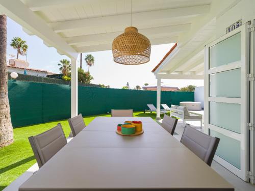 a white table and chairs on a patio at Aquarium Bungalow private jacuzzi, 3 bedrooms, AC and Bikes in Maspalomas