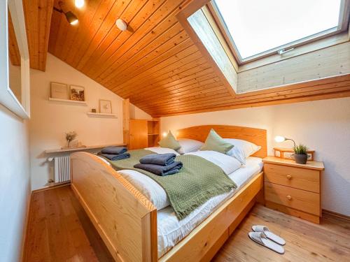 a bedroom with a large bed with a skylight at Ferienwohnung Auszeit in Bad Hindelang