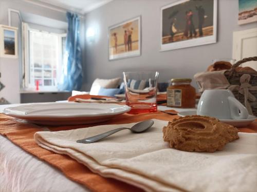a table with plates and utensils on top of it at Quick Home - Casetta Blu in Gaglianico
