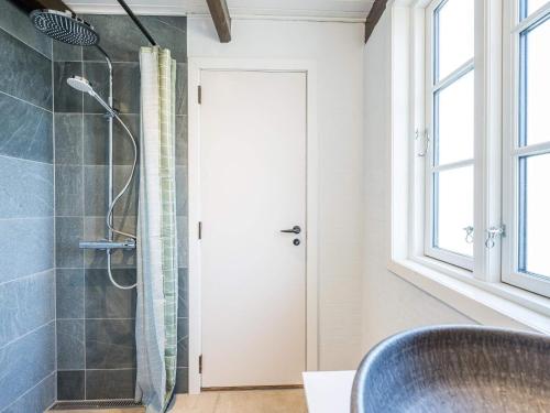 a bathroom with a shower with a glass door at Holiday home Henne CXXVIII in Henne Strand
