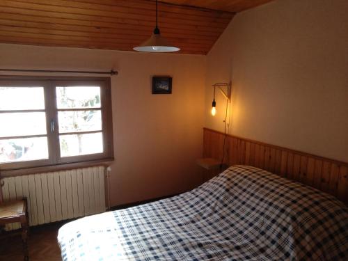 a bedroom with a bed and a window at Gîte de la Séoube in Campan