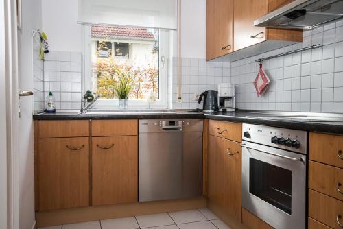 a kitchen with a sink and a stove at Ferienwohnung Bernhardt in Lindau