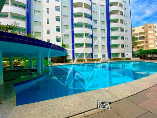 a large swimming pool in front of a building at Águas da Serra TURISMO in Rio Quente