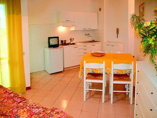 a kitchen with a table and chairs in a room at Flat in Lignano Sabbiadoro in Lignano Sabbiadoro