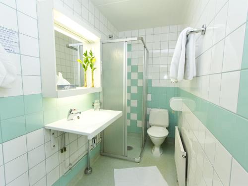 a bathroom with a sink and a toilet at Kauppahotelli in Lahti